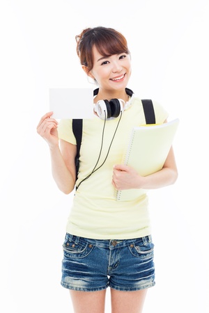 Young Asian student showing empty card isolated on white.の写真素材
