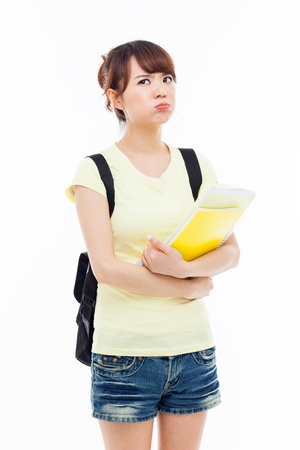 Young Asian stdudent girl having a stress isolated on white.の写真素材