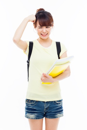 Young Asian stdudent girl having a stress isolated on white.の写真素材