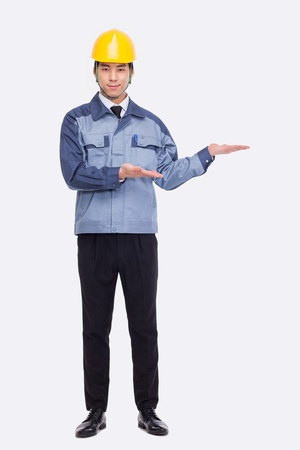 Young Asian engineer show something isolated on white.の写真素材