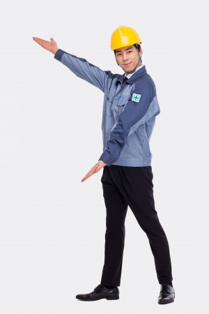 Young Asian engineer show something isolated on white.の写真素材
