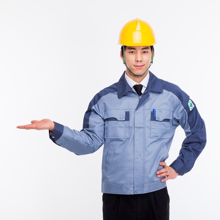 Young Asian engineer show something isolated on white.の写真素材
