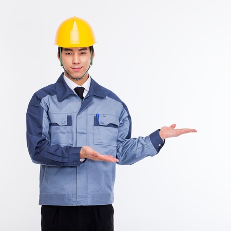 Young Asian engineer show something isolated on white.の写真素材