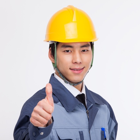 Young Asian engneer showing thumb  isolated on white background. の写真素材