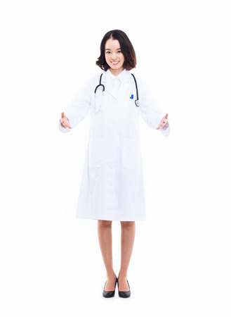 Young Asian woman doctor showing something  isolated on white background. の写真素材