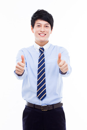 Showing thumb young Asian business man isolated on white background. の写真素材