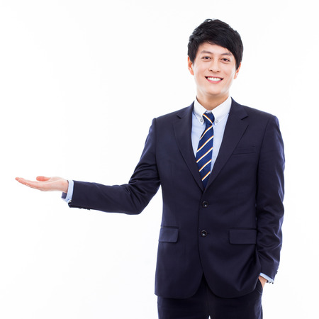 Young Asian business man showing somethingの写真素材