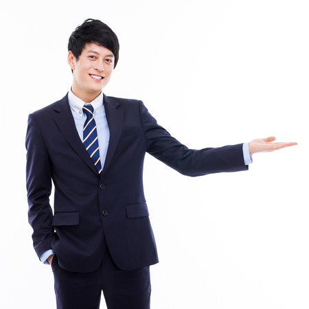 Young Asian business man showing somethingの写真素材