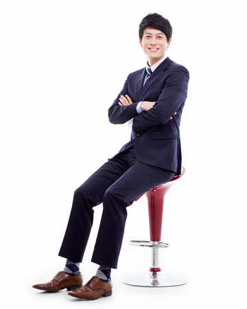 Young Asian business man sitting on the chair の写真素材
