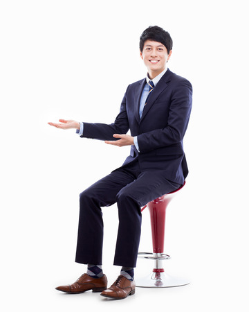 Young Asian business man showing something の写真素材