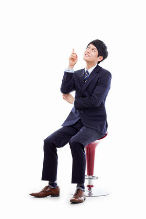 Young Asian business man showing somethingの写真素材