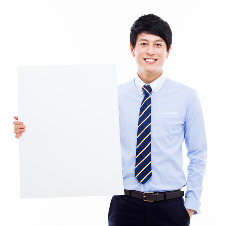 Young Asian business man holding a blank banner の写真素材