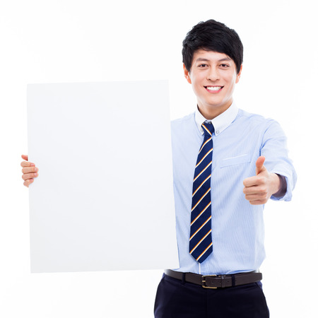 Young Asian business man holding a blank banner の写真素材
