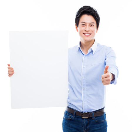 Young Asian man showing a pannel card isolated on white background. の写真素材
