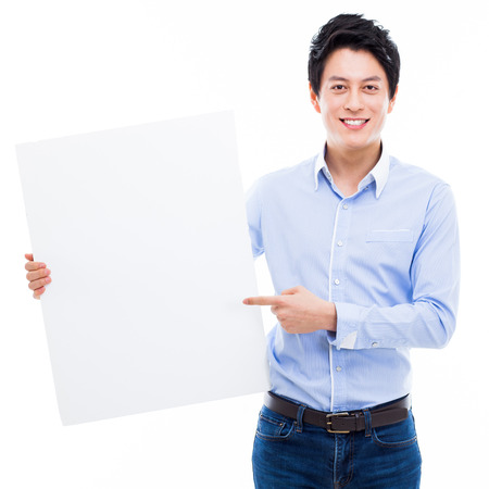 Young Asian man showing a pannel card isolated on white background. の写真素材