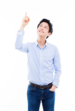 Young asian man indicated upside isolated on white background.の写真素材