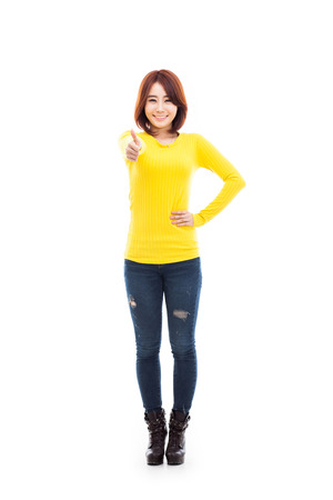 Young Asian woman showing thumb isolated on white background.の写真素材