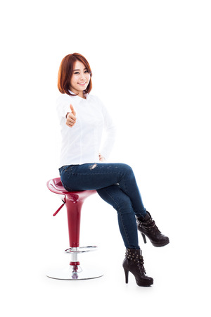 Young Asian woman showing thumb isolated on white background.の写真素材