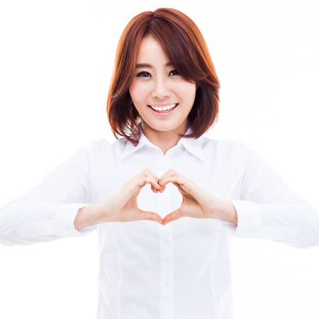 Beautiful Asian casual woman show heart shape isolated on white background. の写真素材