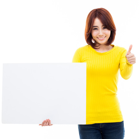 Young Asian woman holding a white board isolated on white background.の写真素材