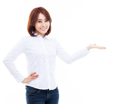 Young Asian woman showing something isolated on white の写真素材
