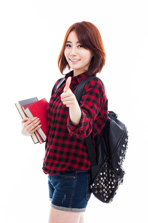 Young happy Asian student show thumb isolated on white.の写真素材