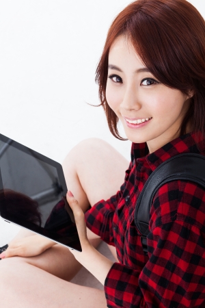 Young Asian student woman using a pad PC isolated on white background. の写真素材