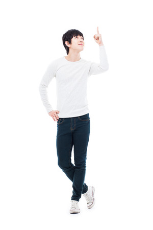 Young asian man indicated upside isolated on white background.の写真素材