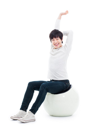 Streching Young Asian man on the chair isolated on white background. の写真素材