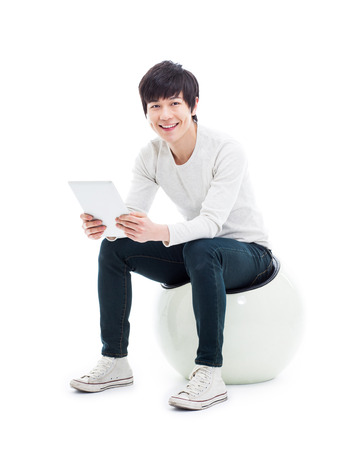 Young Asian man using a Pad PC isolated on white background. の写真素材