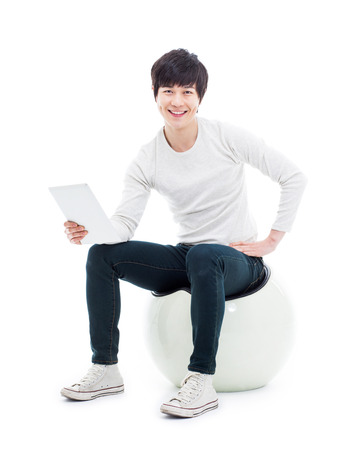 Young Asian man using a Pad PC isolated on white background. の写真素材