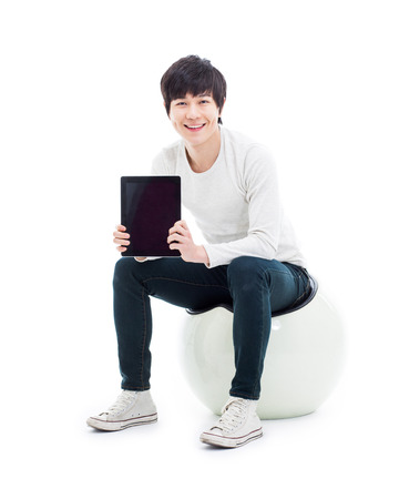 Young Asian man using a Pad PC isolated on white background. の写真素材