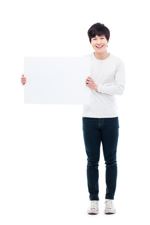 Asian young man showing pannel isolated on white background. の写真素材