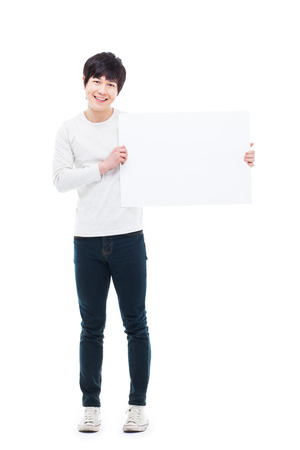 Asian young man showing pannel isolated on white background. の写真素材