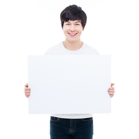 Young Asian man showing a pannel card isolated on white background. の写真素材