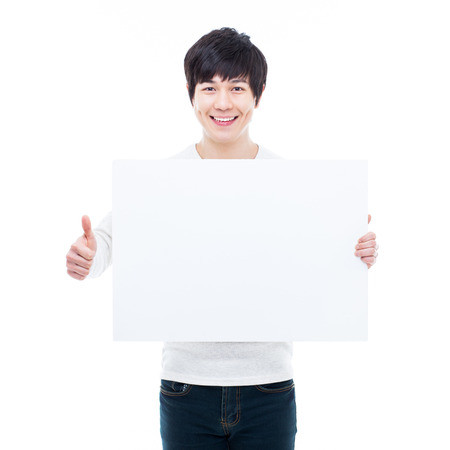 Young Asian man showing a pannel card isolated on white background. の写真素材
