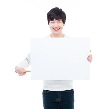 Young Asian man showing a pannel card isolated on white background. の写真素材