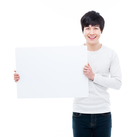 Young Asian man showing a pannel card isolated on white background. の写真素材