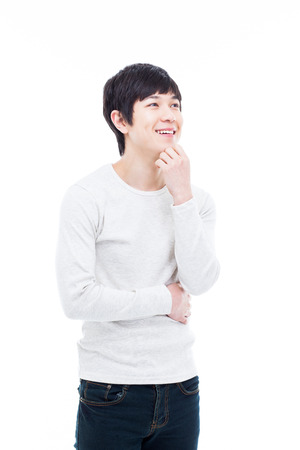 Thinking young Asian man isolated on white background. の写真素材