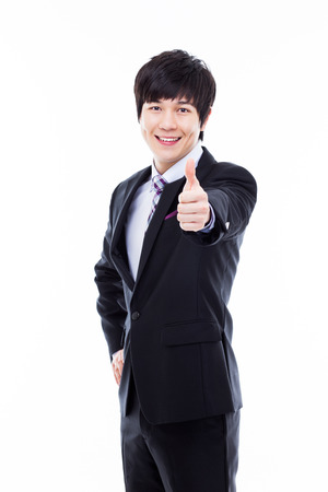 Showing thumb young Asian business man isolated on white . の写真素材
