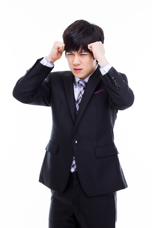 Young Asian man having a stress on isolated on white background.の写真素材