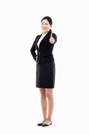 Successful happy Asian businesswoman showing thumb isolated on white background. の写真素材