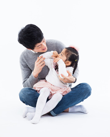 Happy Asian father and daugther isolated on white background. の写真素材