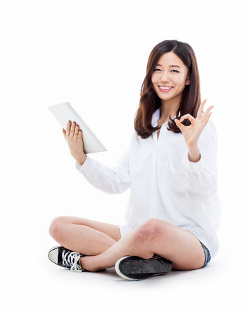 Woman holding tablet computer isolated on white background.の写真素材