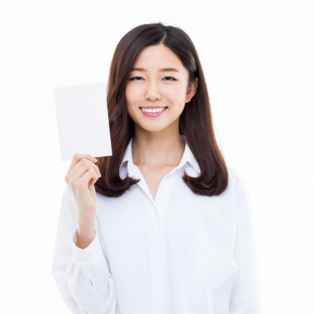 Asian woman showing empty card isolated on white background.の写真素材