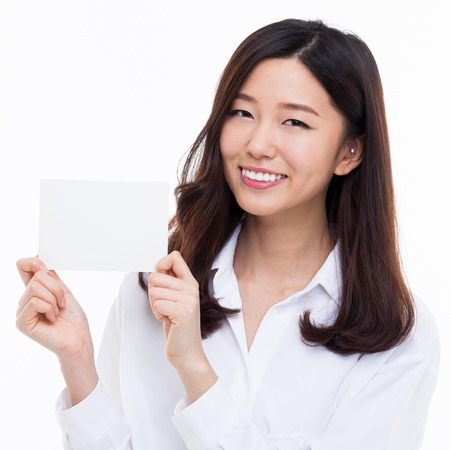 Asian woman showing empty card isolated on white background.の写真素材
