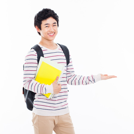 Young Asian student present something isolated on white background.の写真素材
