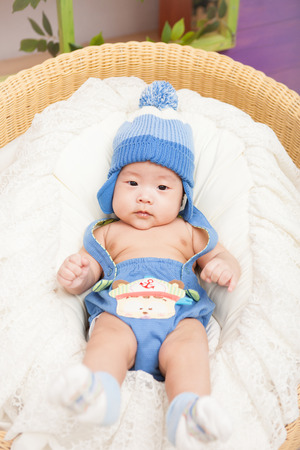 Lying Asian baby in stuio backgound.の写真素材