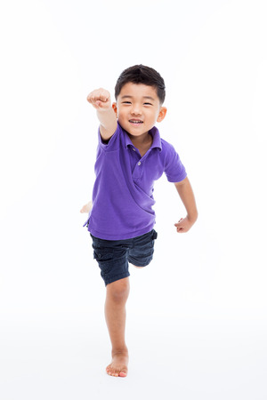 Young happy Asian boy isolated on white background.の写真素材