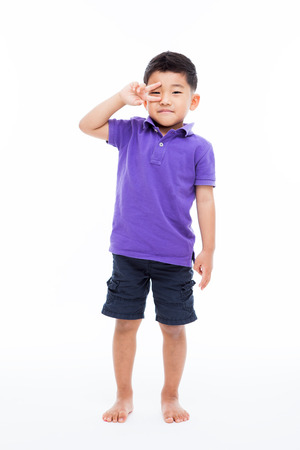 Young happy Asian boy isolated on white background.の写真素材